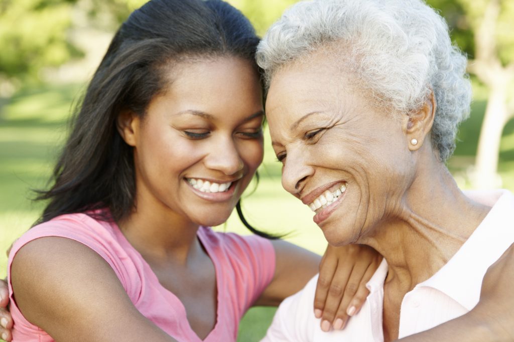 african-american-mother-and-adult-daughter-relaxing-in-park-1